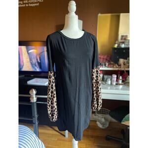 BLACK KNEE LENGTH DRESS WITH CHEETAH PRINT SLEEVES. IN GOOD CONDITION.